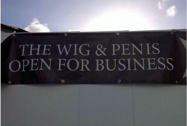 sign saying The Wig & Penis Is Open For Business