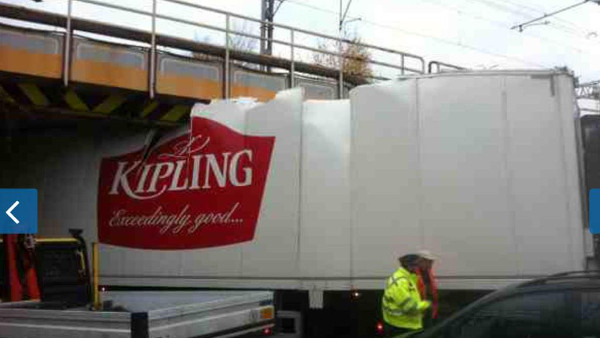 photo of Mr Kipling lorry stuck under bridge