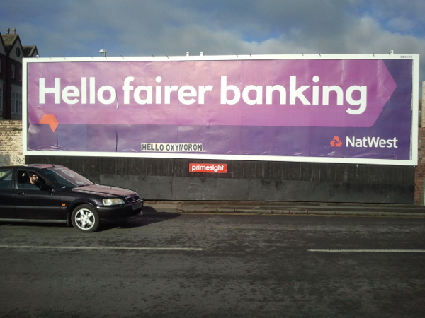 billboard with slogan hello fairer banking subvertised with added hello oxymoron text