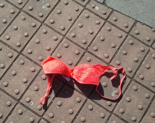 shot of red bra on footway