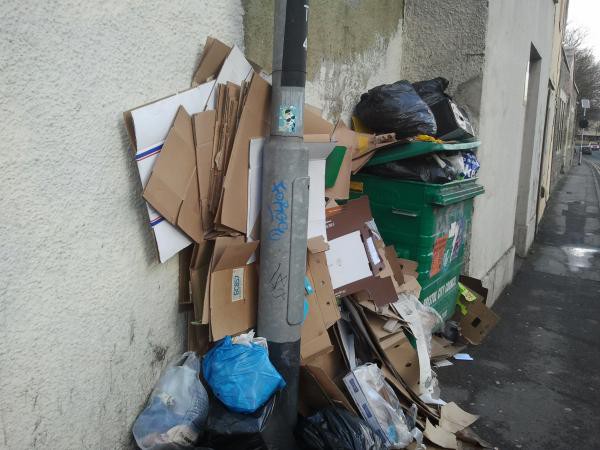 image of trade waste - in this case lots of flattened cardboard packaging - fly-tipped by communal bin in Pennywell Road, Easton